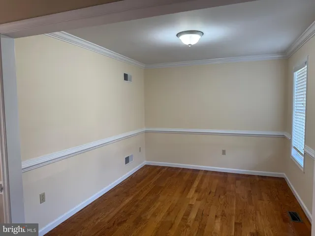 a view of room with window and wooden floor