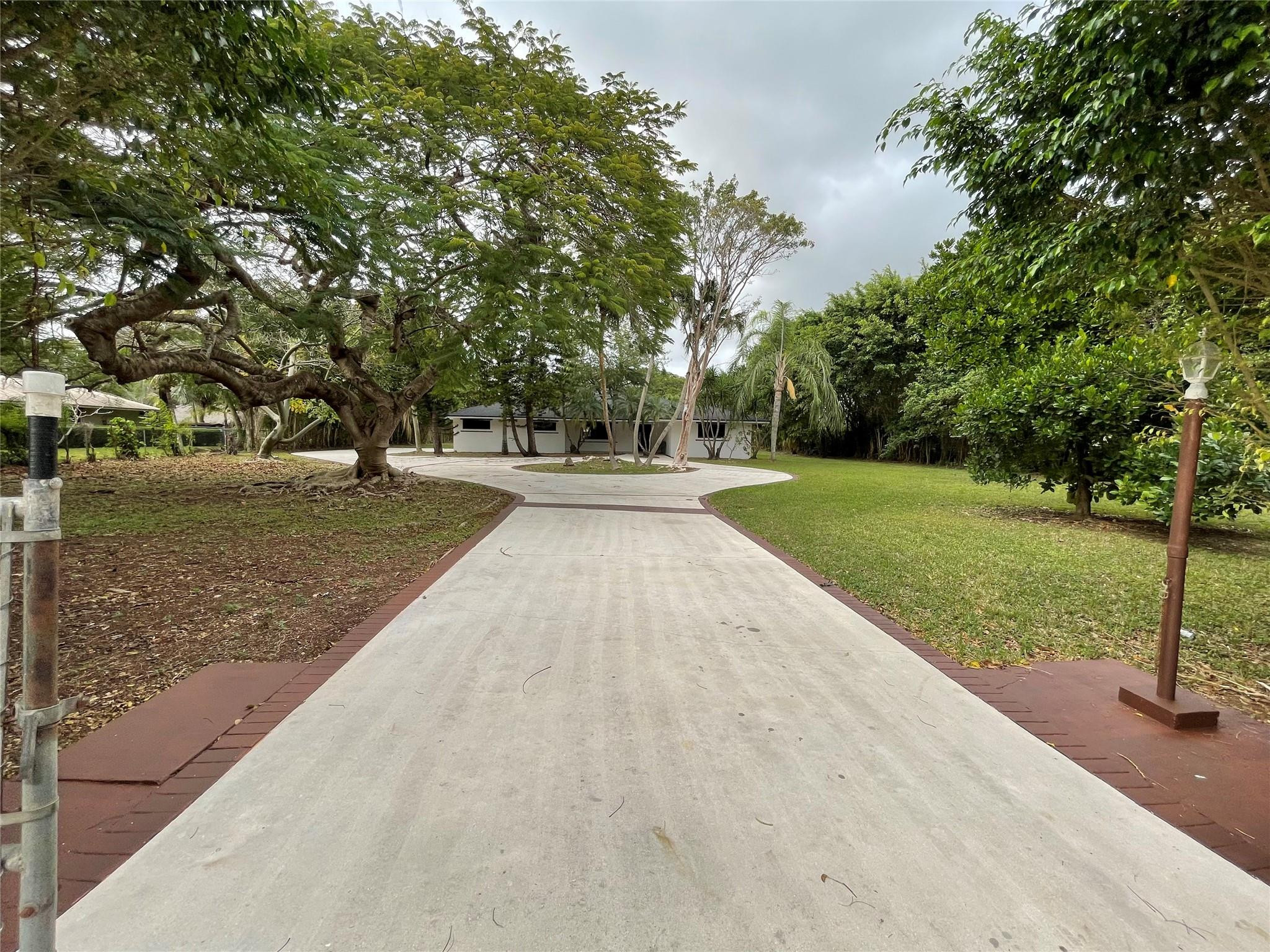 16881 Southwest 276th Street Homestead, FL 33031 - Photo 2 of 17 a view of a yard with flower plants
