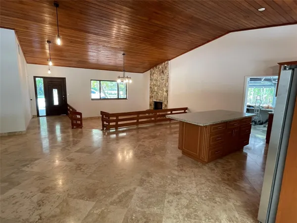 a room with pool table and windows