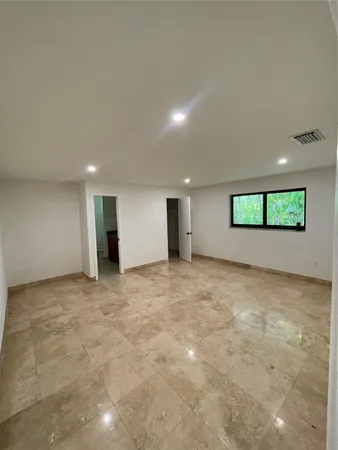 a view of an empty room with a window