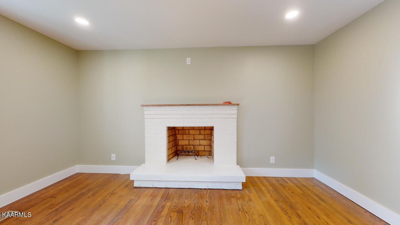 3877 Riverview Road Lenoir City, TN 37771 - Photo 12 of 47 a view of empty room with wooden floor and fireplace