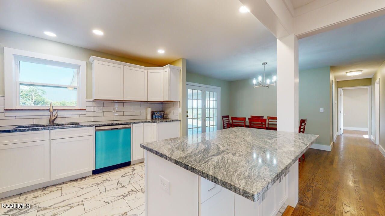 3877 Riverview Road Lenoir City, TN 37771 - Photo 13 of 47 a kitchen with kitchen island granite countertop a sink and white cabinets