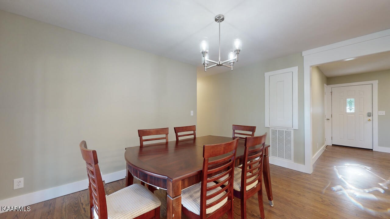 3877 Riverview Road Lenoir City, TN 37771 - Photo 19 of 47 a view of a dining room with furniture and wooden floor