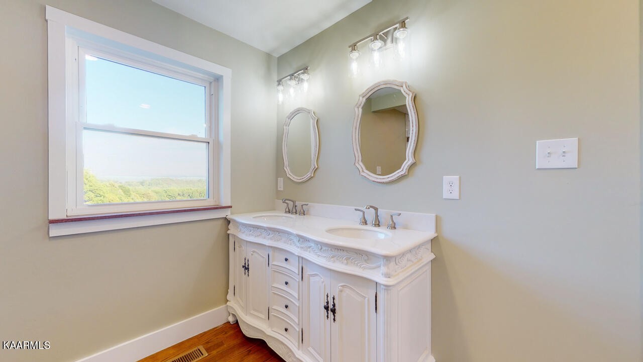 3877 Riverview Road Lenoir City, TN 37771 - Photo 23 of 47 a bathroom with a double vanity sink and a mirror