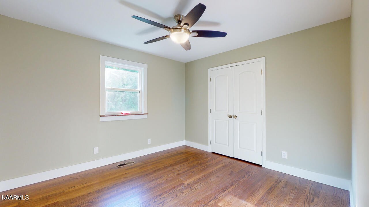 3877 Riverview Road Lenoir City, TN 37771 - Photo 26 of 47 a view of a room with wooden floor and a ceiling fan