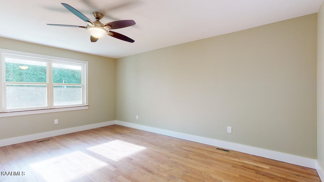 3877 Riverview Road Lenoir City, TN 37771 - Photo 30 of 47 an empty room with a window and ceiling fan