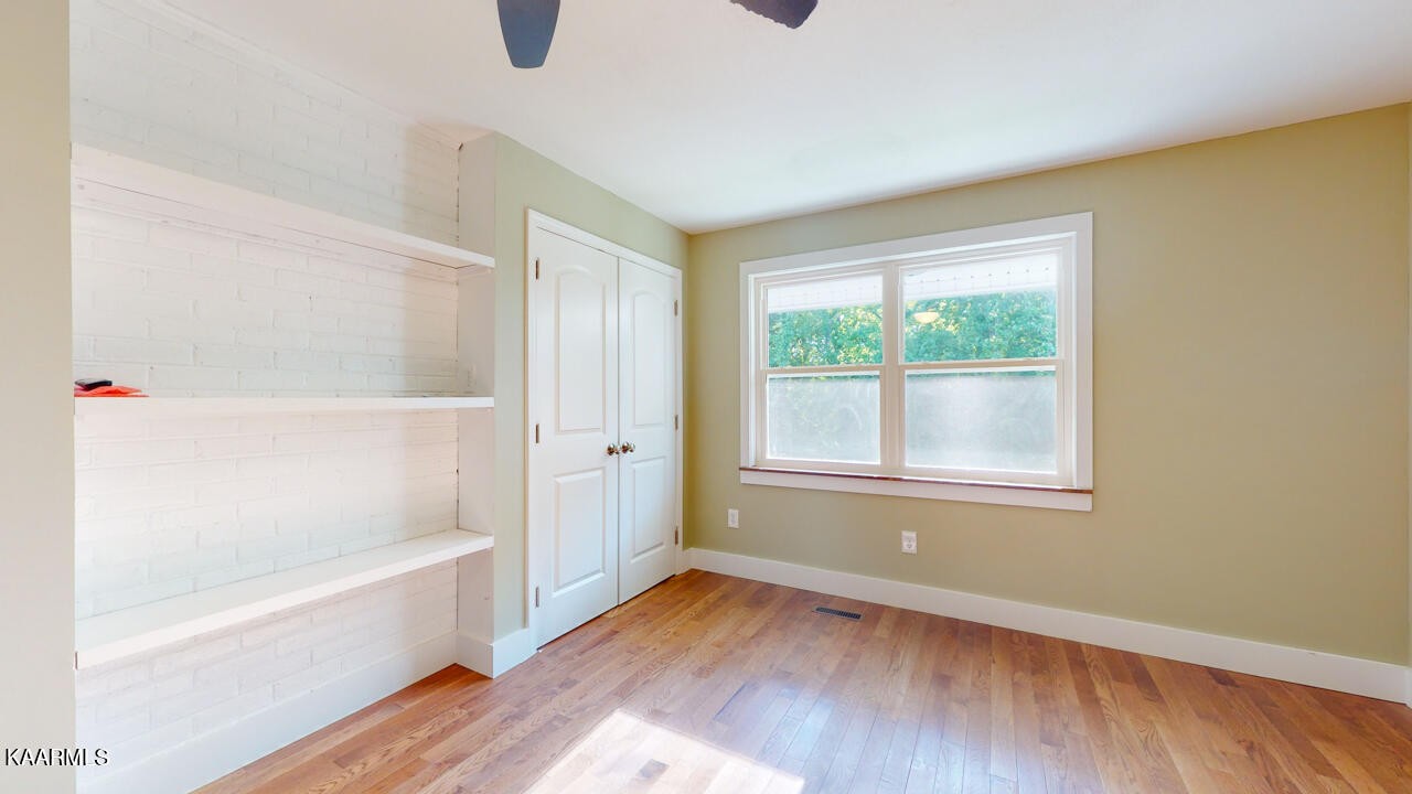 3877 Riverview Road Lenoir City, TN 37771 - Photo 31 of 47 a view of an empty room with wooden floor and a window