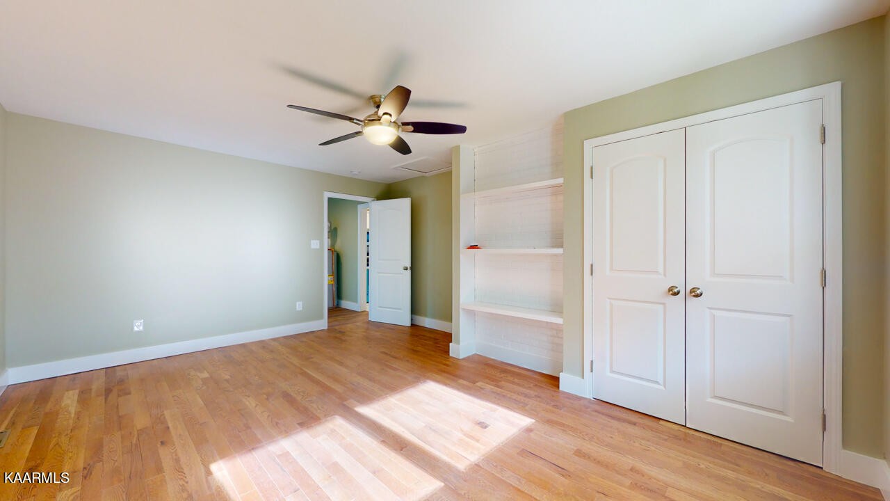 3877 Riverview Road Lenoir City, TN 37771 - Photo 32 of 47 a view of empty room with wooden floor and fan