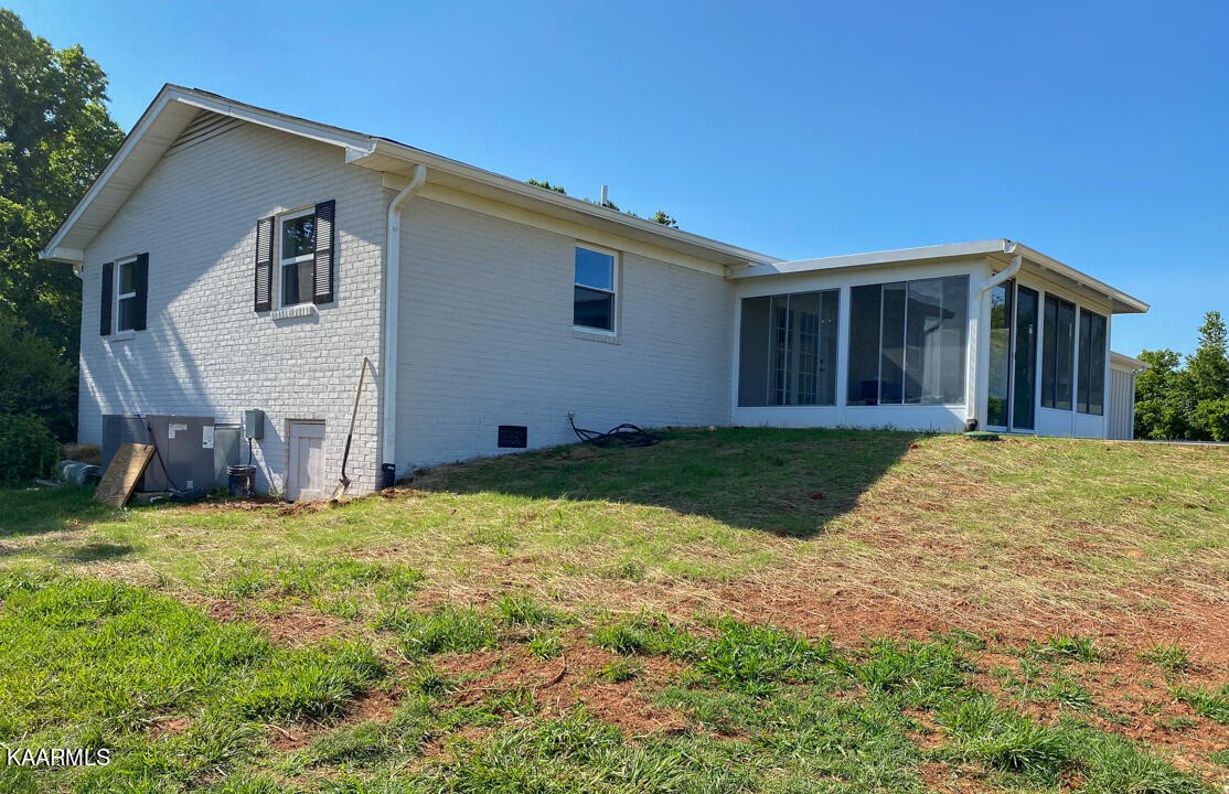 3877 Riverview Road Lenoir City, TN 37771 - Photo 34 of 47 a view of a house with a yard and garage