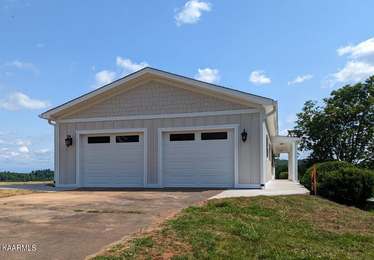 3877 Riverview Road Lenoir City, TN 37771 - Photo 36 of 47 a front view of a house with a yard and garage