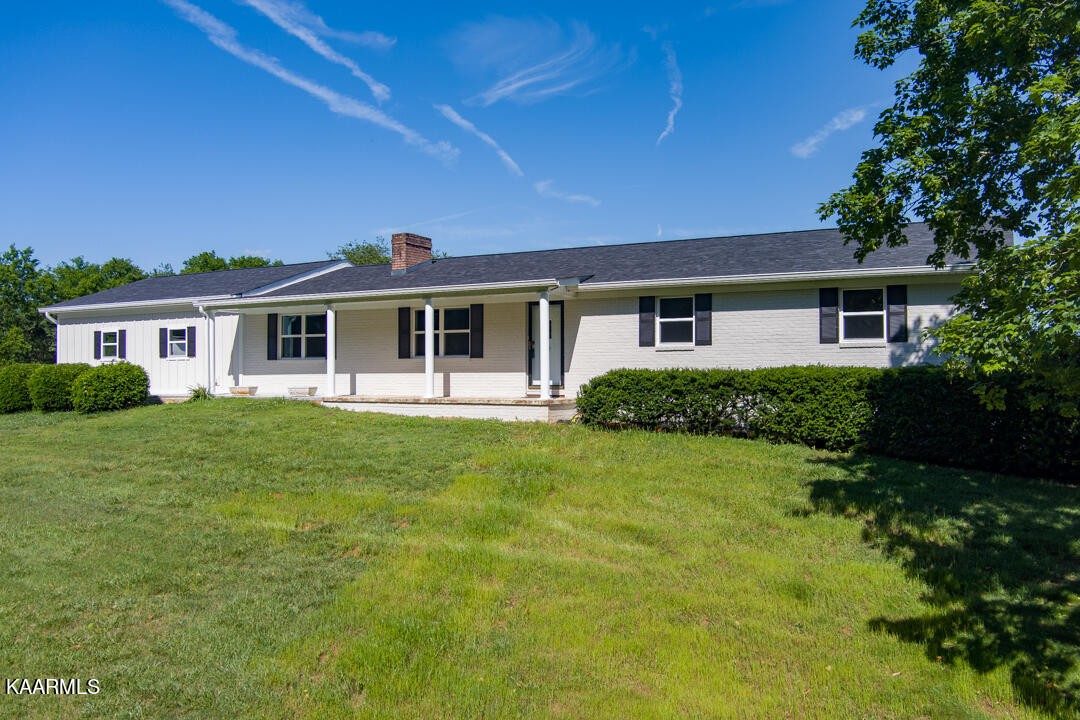 3877 Riverview Road Lenoir City, TN 37771 - Photo 5 of 47 a front view of a house with a garden