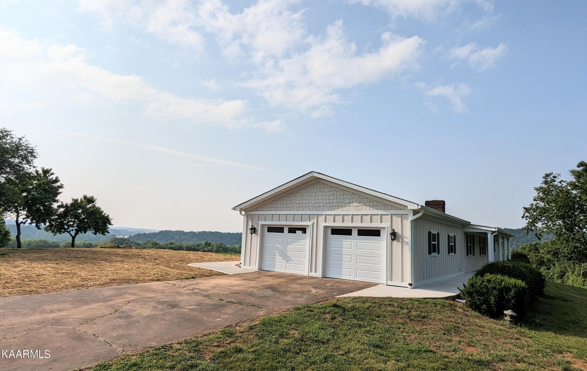 3877 Riverview Road Lenoir City, TN 37771 - Photo 6 of 47 a view of a house with a yard and large trees