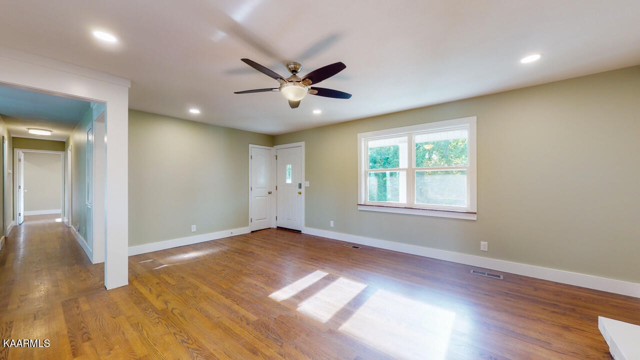 3877 Riverview Road Lenoir City, TN 37771 - Photo 10 of 47 a view of an empty room with window and wooden floor