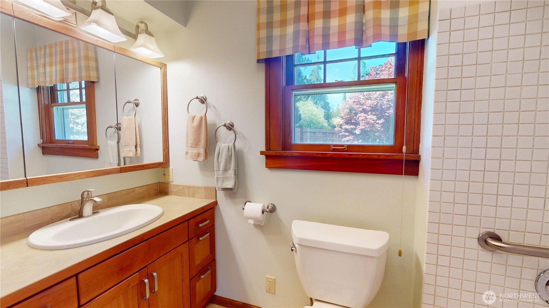 1533 Northeast Tagholm Road Poulsbo, WA 98370 - Photo 8 of 40 a bathroom with a sink and a mirror