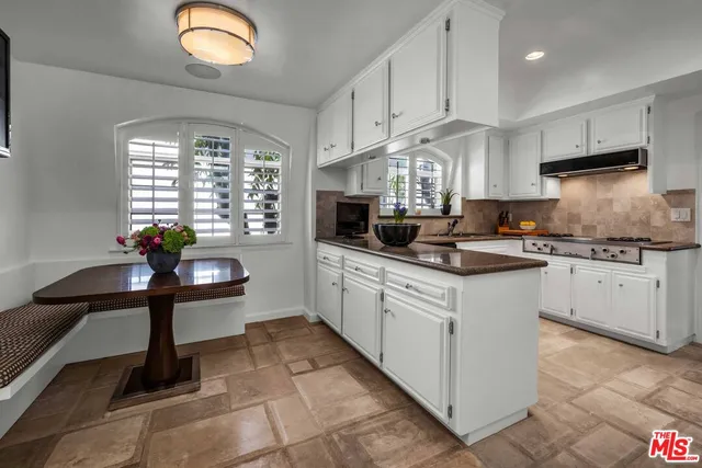 a kitchen with stainless steel appliances granite countertop a stove a sink dishwasher and a refrigerator