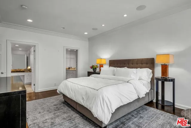 a bedroom with a bed and a mirror