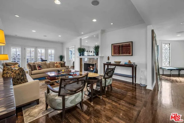 a living room with fireplace furniture and a wooden floor