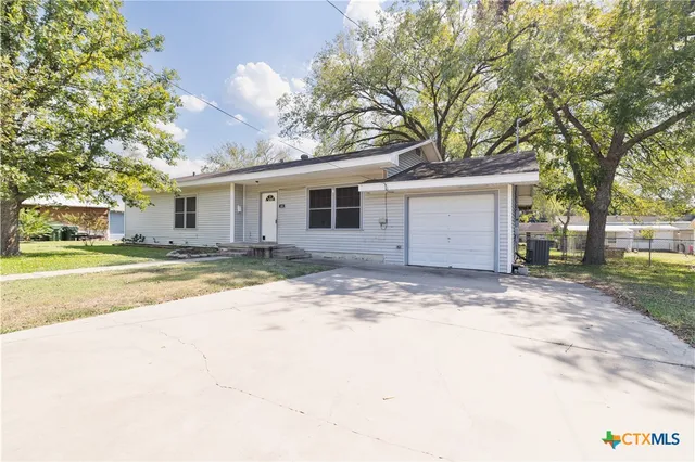 a view of house with outdoor space and tree s