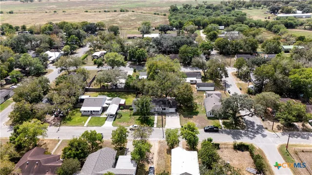 an aerial view of residential building with green space