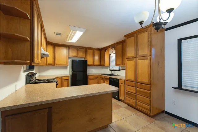 a kitchen with stainless steel appliances a refrigerator and a sink