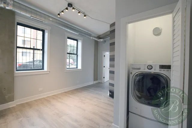 a view of a hallway with washer and dryer