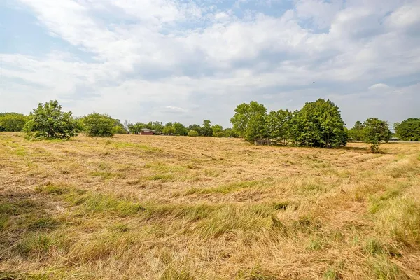 an aerial view of a house with yard