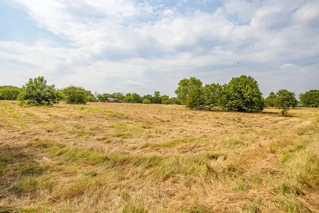 an aerial view of a house with yard