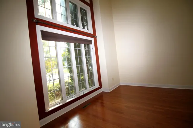a large kitchen with a large window and stainless steel appliances