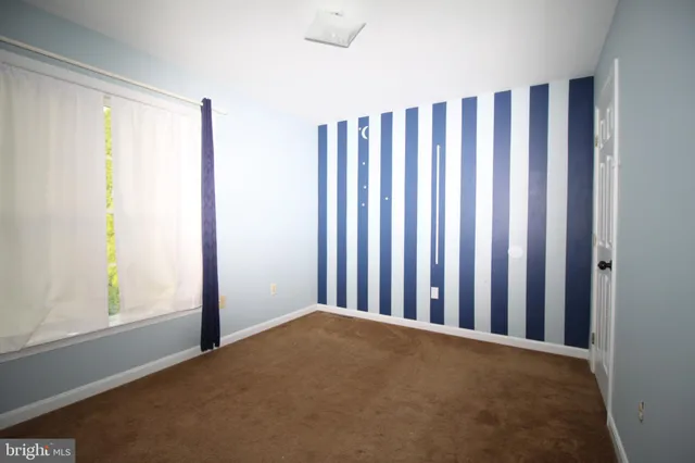 an empty room with windows and entrance