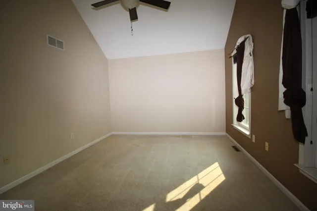 a bathroom with a granite countertop sink toilet and a mirror