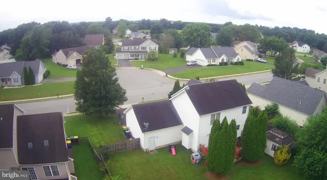 an aerial view of a house with outdoor space swimming pool