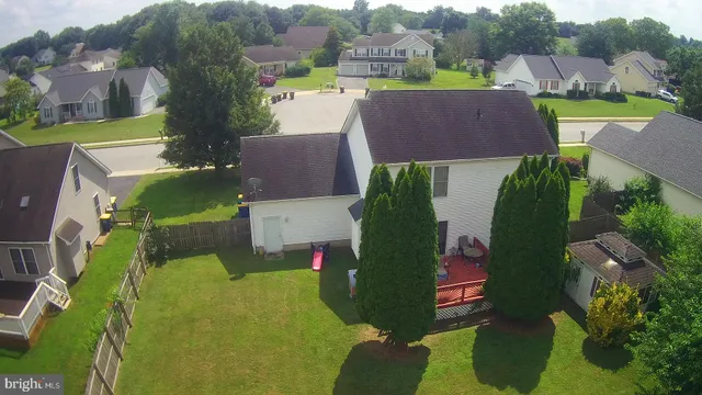 an aerial view of a house with a garden and trees