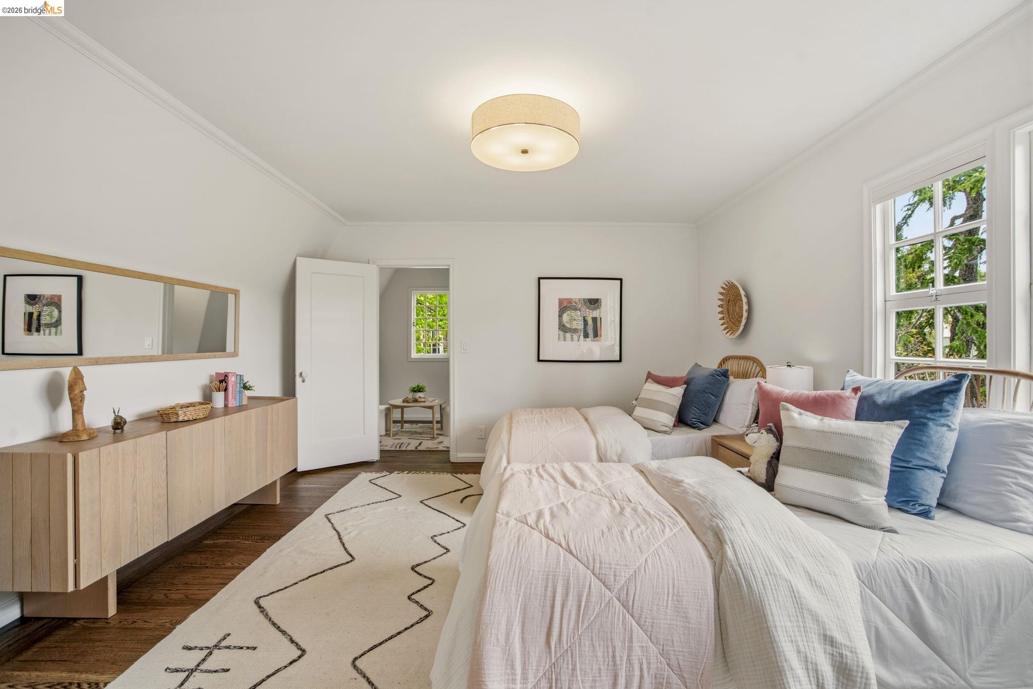 1087 Hubert Road Oakland, CA 94610 - Photo 30 of 67 Room featuring hardwood flooring, white walls, and a drum ceiling light fixture
