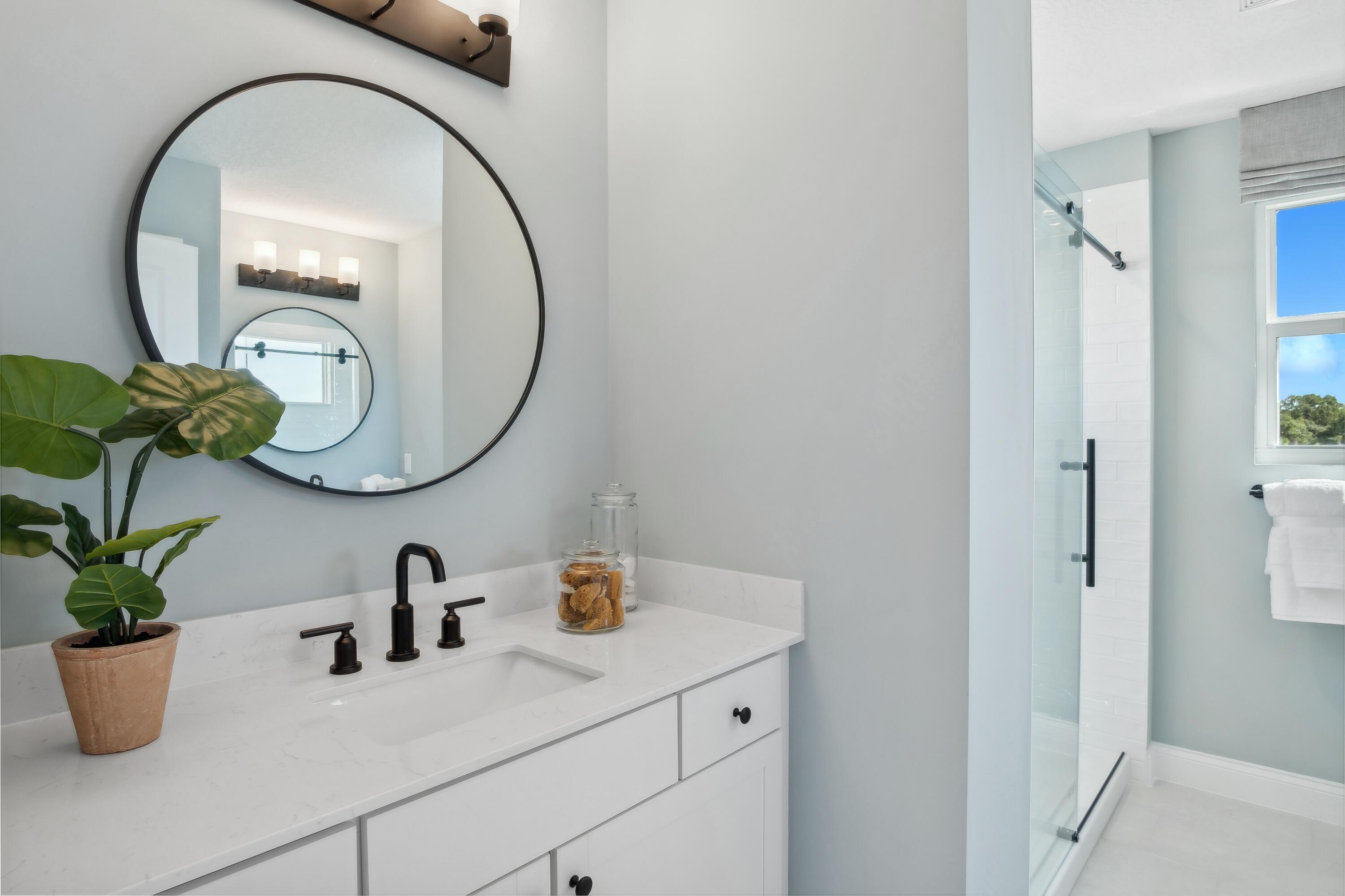 181 Southeast Birch Terrace, Unit 735 Stuart, FL 34997 - Photo 32 of 44 a bathroom with a sink and a mirror