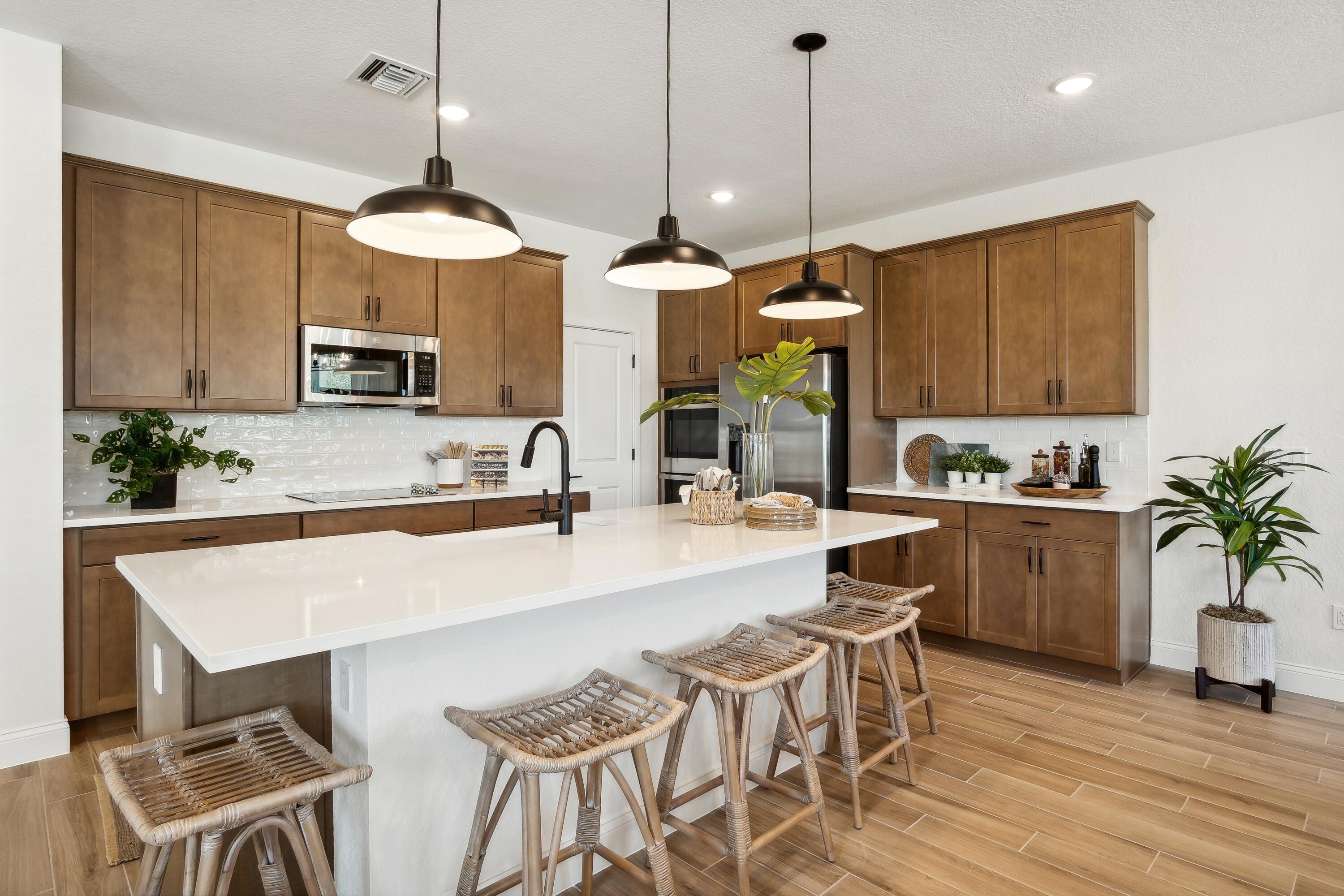 181 Southeast Birch Terrace, Unit 735 Stuart, FL 34997 - Photo 6 of 44 a kitchen with a table and chairs in it