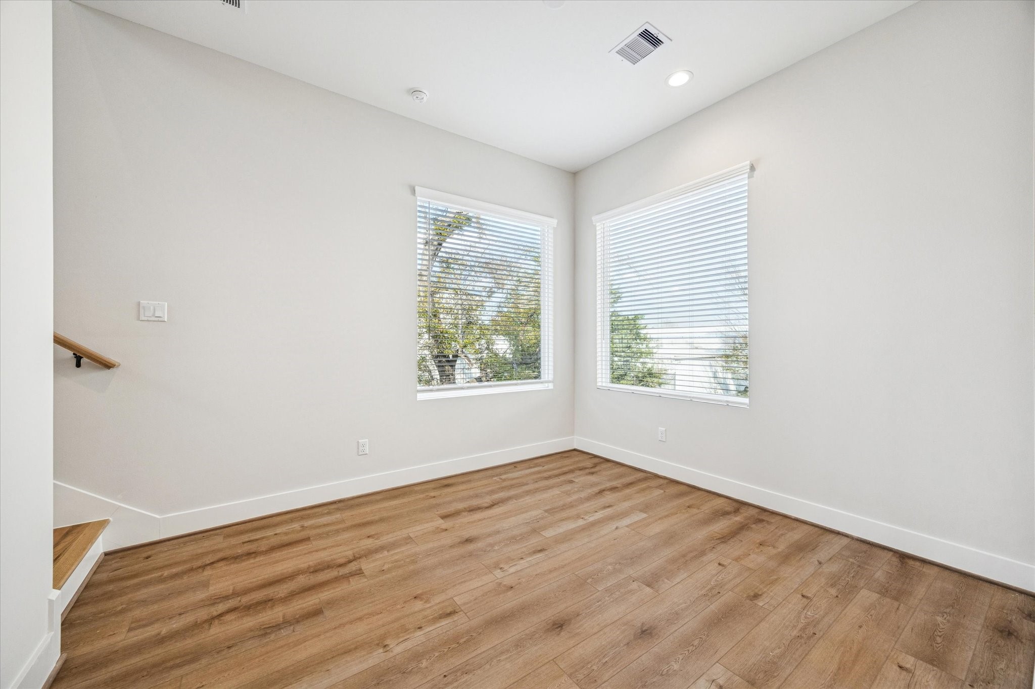 520 Janisch Road Houston, TX 77018 - Photo 12 of 28 an empty room with wooden floor and windows