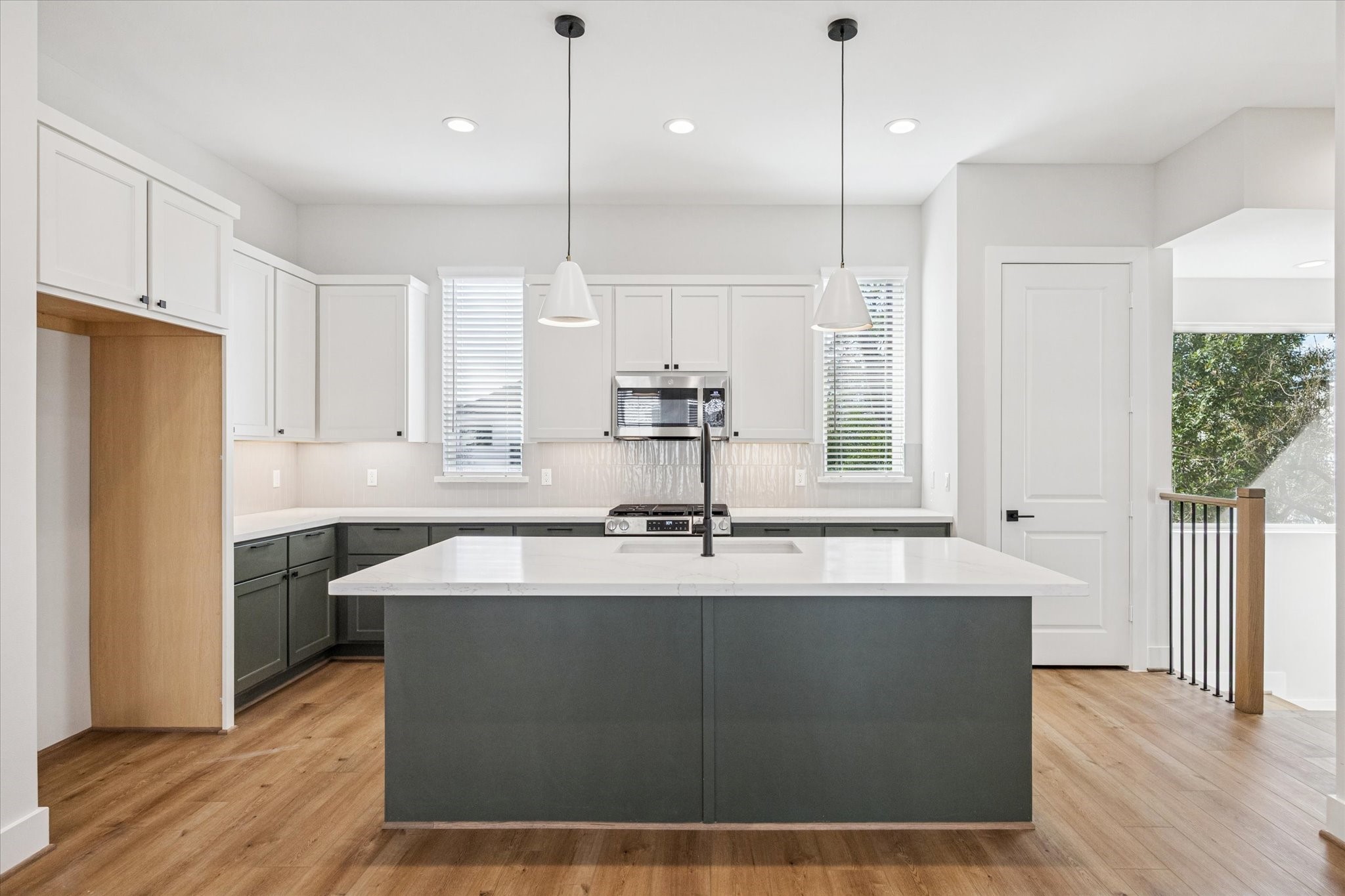 520 Janisch Road Houston, TX 77018 - Photo 2 of 28 a kitchen with kitchen island a counter top space a sink stainless steel appliances and cabinets