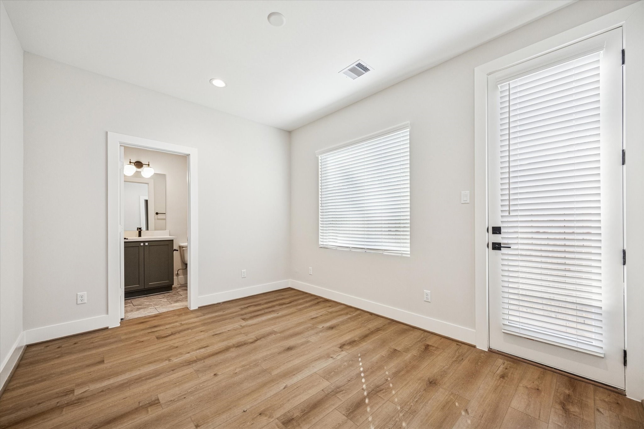520 Janisch Road Houston, TX 77018 - Photo 21 of 28 an empty room with wooden floor and windows