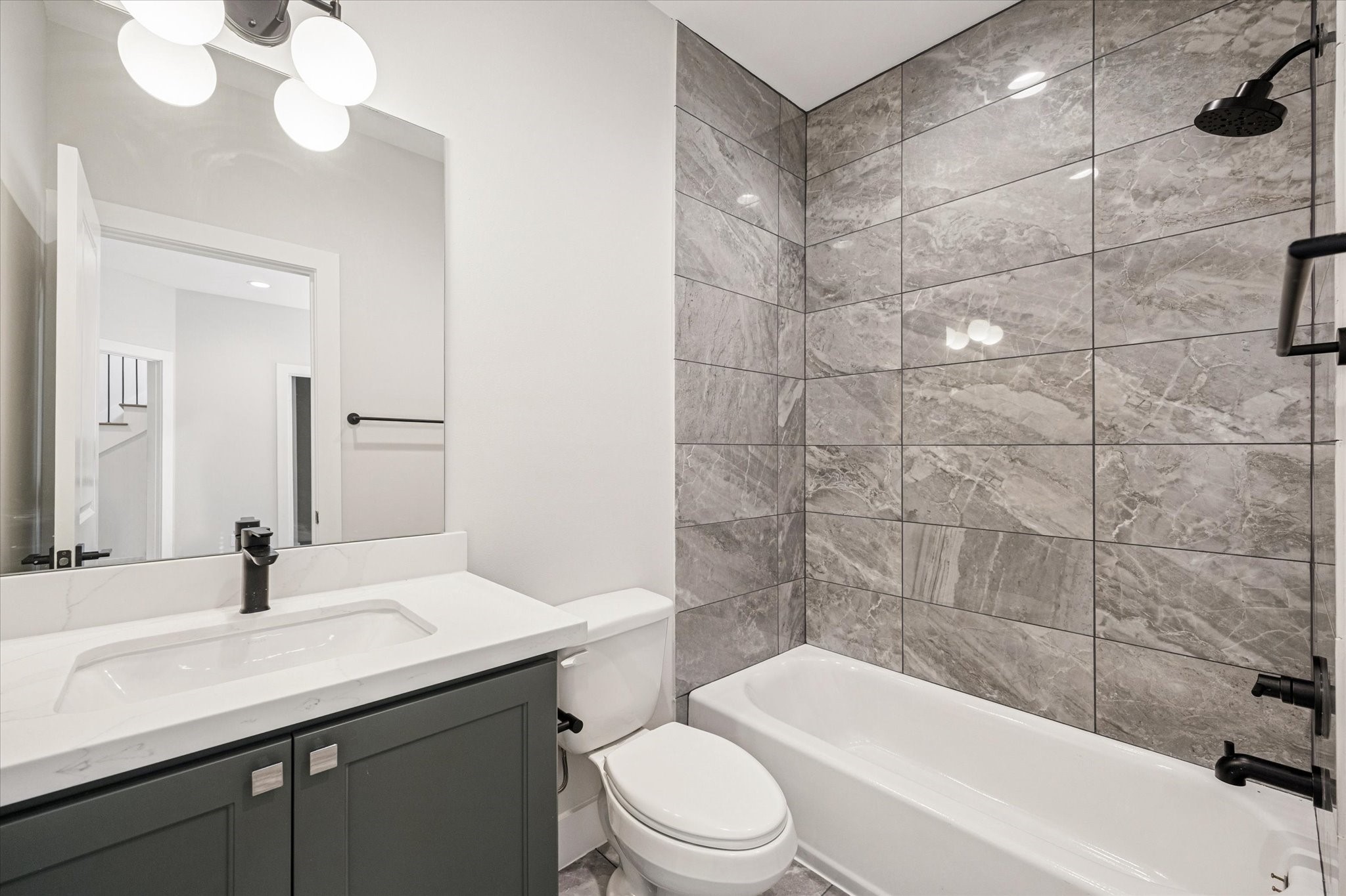 520 Janisch Road Houston, TX 77018 - Photo 22 of 28 a bathroom with a sink a toilet a mirror a vanity and bathtub