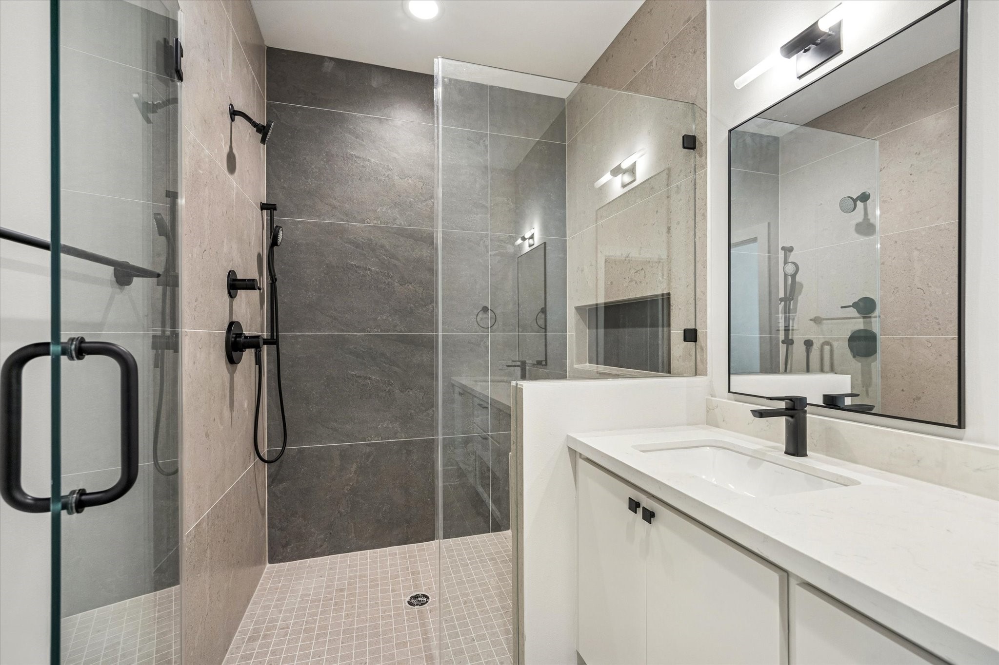 520 Janisch Road Houston, TX 77018 - Photo 3 of 28 a bathroom with a shower sink and mirror