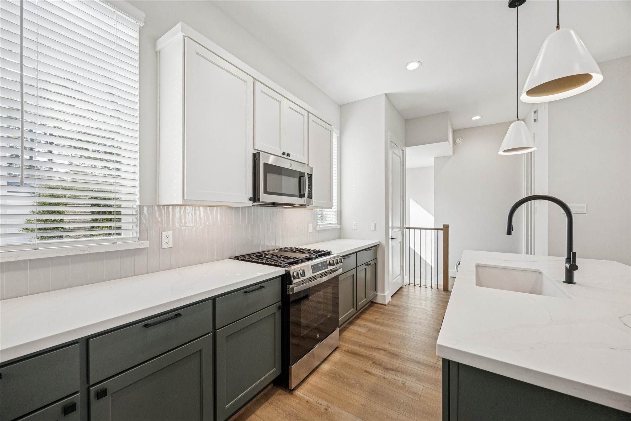520 Janisch Road Houston, TX 77018 - Photo 4 of 28 a kitchen with a sink a stove and cabinets