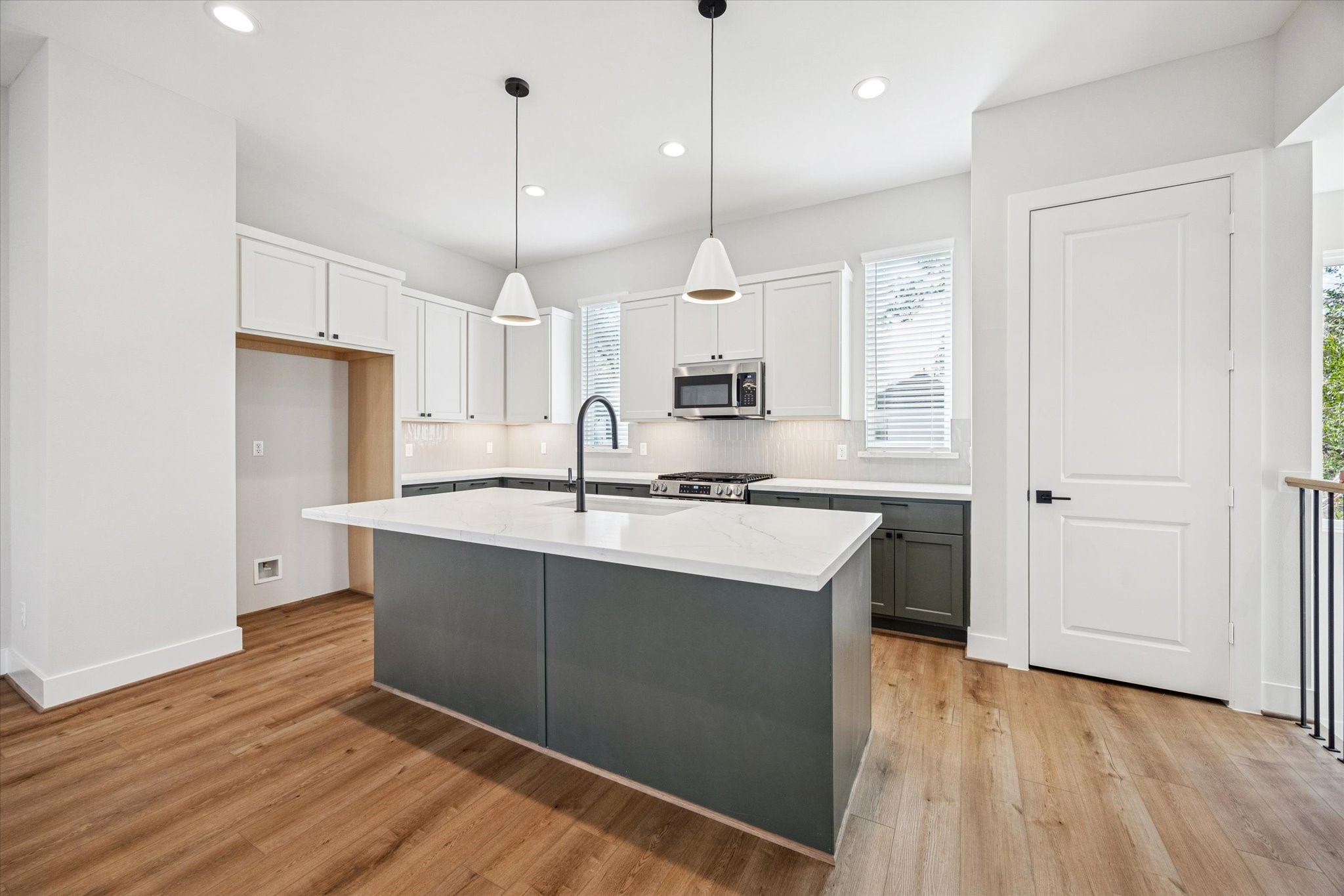 520 Janisch Road Houston, TX 77018 - Photo 5 of 28 a kitchen with kitchen island a sink stainless steel appliances and cabinets