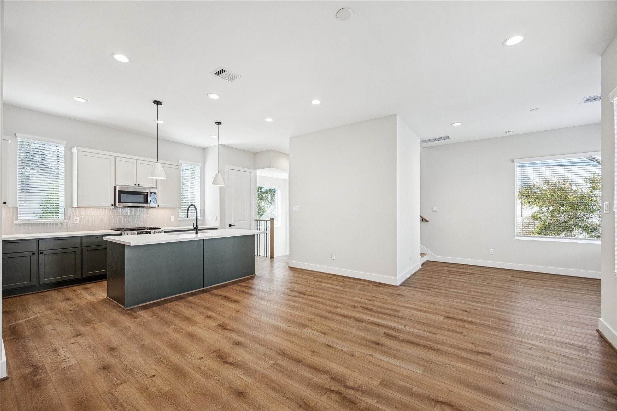 520 Janisch Road Houston, TX 77018 - Photo 9 of 28 a large kitchen with a wooden floor and a large window