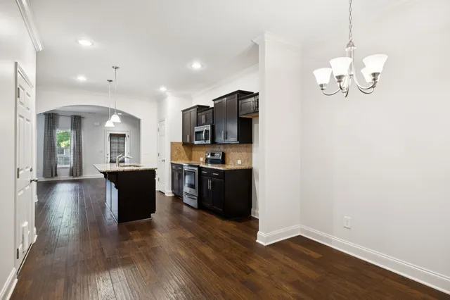 a view of kitchen with refrigerator microwave and stove