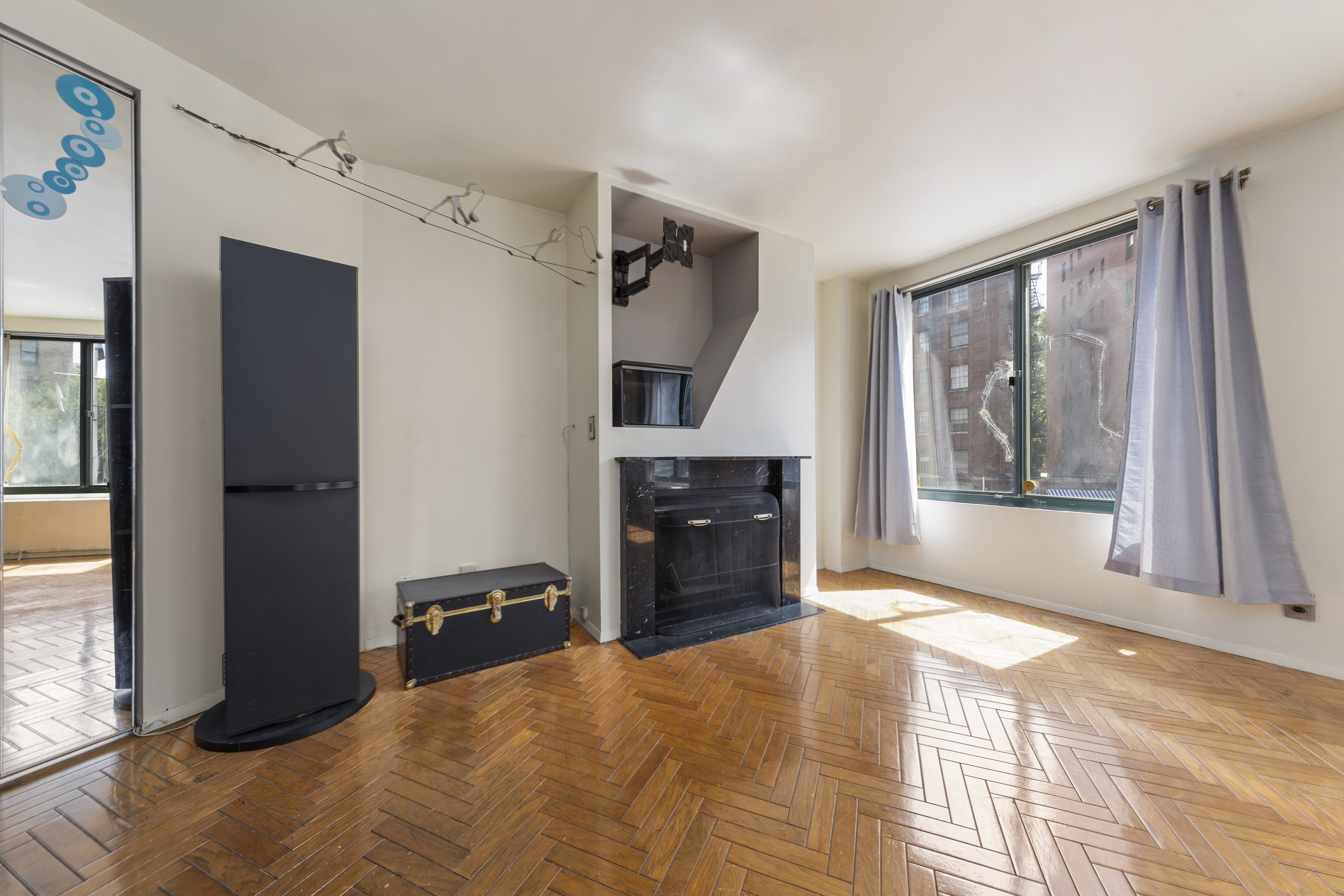 22 Perry Street, Unit 2B Manhattan, NY 10014 - Photo 2 of 9 a bedroom with a bed and a large window