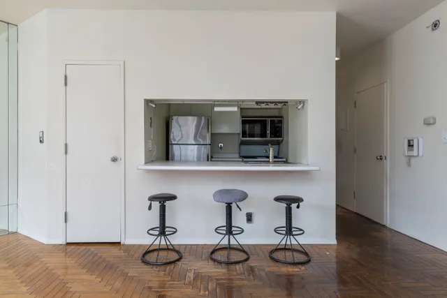 a bathroom with a granite countertop bathtub sink vanity mirror and toilet