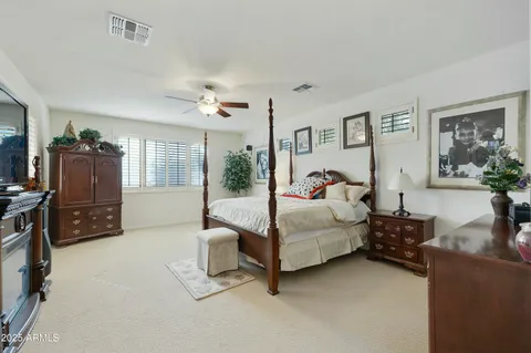 a bedroom with furniture and a flat screen tv