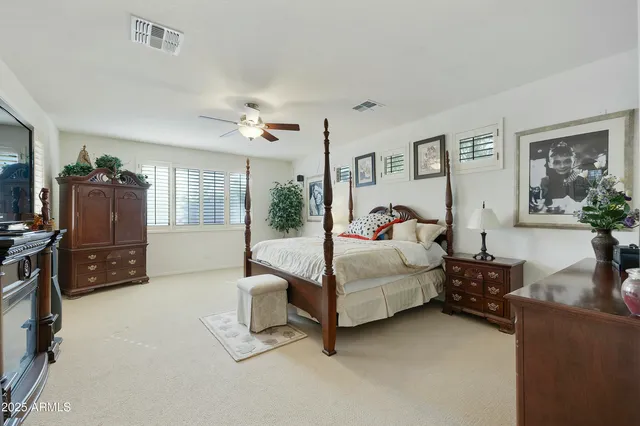 a bedroom with furniture and a flat screen tv