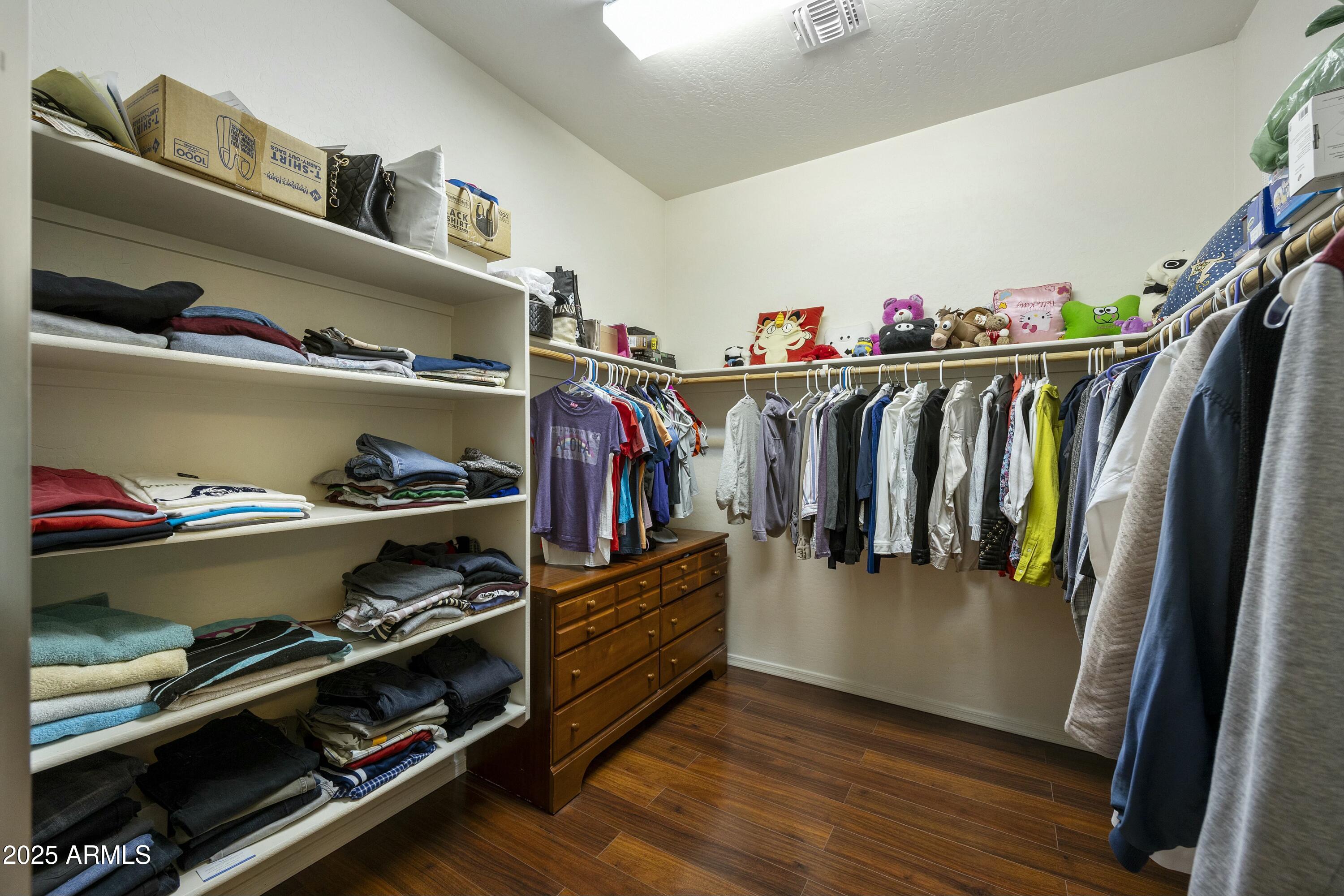 4615 West Corral Road Laveen, AZ 85339 - Photo 23 of 48 a view of walk in closet with clothes and shoes