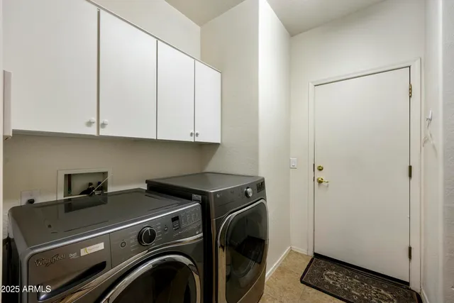 a view of a storage and utility room with washer and dryer